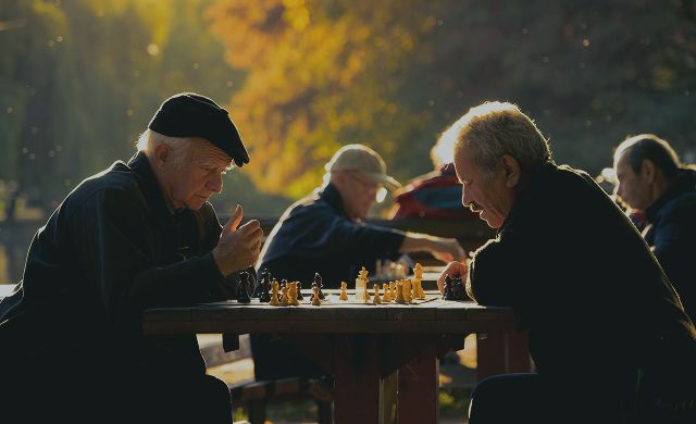 Elderly men playing chess